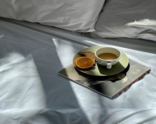 Open book and tea on bed